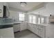 Bright kitchen features white cabinets, an island, stainless steel appliances, and a blue backsplash at 11212 Bayridge E Cir, Indianapolis, IN 46236