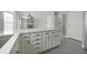 Bright kitchen features white cabinets, an island, stainless steel appliances, and a blue backsplash at 11212 Bayridge E Cir, Indianapolis, IN 46236