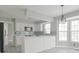 Bright kitchen features white cabinets, an island, stainless steel appliances, and a blue backsplash at 11212 Bayridge E Cir, Indianapolis, IN 46236