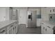 Bright kitchen features white cabinets, an island, stainless steel appliances, and a blue backsplash at 11212 Bayridge E Cir, Indianapolis, IN 46236