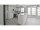 Bright modern kitchen with white cabinets, stainless steel appliances, and a stylish blue tile backsplash at 11212 Bayridge E Cir, Indianapolis, IN 46236