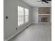 Open-concept living room features a brick fireplace, a ceiling fan, and neutral paint at 11212 Bayridge E Cir, Indianapolis, IN 46236