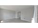 Comfortable living room features French doors, light gray walls, white trim and durable gray laminate flooring at 11212 Bayridge E Cir, Indianapolis, IN 46236