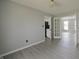 Inviting living room featuring a French door, light gray walls, white trim, and laminate flooring at 11212 Bayridge E Cir, Indianapolis, IN 46236