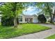 Beautiful yellow house with lush green lawn and mature trees shading the property at 1127 Jody Ct, Greenwood, IN 46143