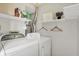 A well-maintained laundry room with washer, dryer, and shelving at 1127 Jody Ct, Greenwood, IN 46143