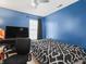 Modern bedroom with a comfortable bed, large window, and entertainment center, perfect for relaxation at 11327 Cuyahoga Dr, Indianapolis, IN 46235