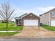 Charming single-Gathering home with brick facade, attached two-car garage, and well-maintained lawn at 11327 Cuyahoga Dr, Indianapolis, IN 46235
