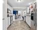 Efficient kitchen featuring stainless appliances, white cabinets and neutral countertops overlooking open floor plan at 11327 Cuyahoga Dr, Indianapolis, IN 46235