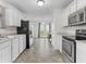 Well-lit kitchen featuring white cabinets and stainless steel appliances at 11327 Cuyahoga Dr, Indianapolis, IN 46235