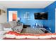 Cozy living room with blue accent wall, modern furniture, and a large screen television at 11327 Cuyahoga Dr, Indianapolis, IN 46235