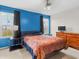 Inviting main bedroom featuring blue accent wall, neutral carpet, and bright windows at 11327 Cuyahoga Dr, Indianapolis, IN 46235
