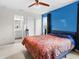 Comfortable main bedroom with ceiling fan, bright windows, and an ensuite bathroom at 11327 Cuyahoga Dr, Indianapolis, IN 46235