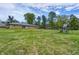 Spacious backyard featuring a well-manicured lawn, playset, and charming ranch style home at 12078 N 125 W, Alexandria, IN 46001