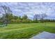 Expansive backyard with mature trees, a well-maintained lawn, and a charming playset at 12078 N 125 W, Alexandria, IN 46001