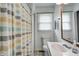 Bright bathroom featuring a vanity with a white sink and a shower with a patterned curtain at 12078 N 125 W, Alexandria, IN 46001