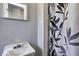 Bathroom featuring a white pedestal sink and black and white shower curtain, with tiled walls at 12078 N 125 W, Alexandria, IN 46001
