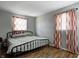 Bedroom with hardwood floors and windows with patterned curtains at 12078 N 125 W, Alexandria, IN 46001
