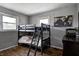 Cozy bedroom features a rustic wood floor, bunk beds, and a decorative world map on the wall at 12078 N 125 W, Alexandria, IN 46001