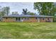 Ranch style home with a brick facade and large green lawn at 12078 N 125 W, Alexandria, IN 46001