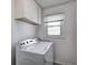 Bright laundry room with a modern washer and dryer, complemented by white cabinets above at 12078 N 125 W, Alexandria, IN 46001
