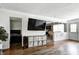 Open-concept living area with hardwood floors, television, and view into dining and kitchen at 12078 N 125 W, Alexandria, IN 46001
