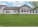 Backyard featuring a well-manicured lawn and a view of the back exterior of the home at 12698 Whisper Way, Fishers, IN 46037
