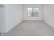 Minimalist bedroom featuring neutral carpet, white walls and a light-filled window at 12698 Whisper Way, Fishers, IN 46037