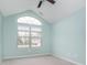 Bright bedroom featuring a vaulted ceiling, ceiling fan and a large window letting in natural light at 12698 Whisper Way, Fishers, IN 46037