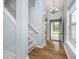 Inviting entryway featuring hardwood floors, neutral paint, and a staircase to the upper level at 12698 Whisper Way, Fishers, IN 46037