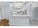 Well-lit kitchen featuring white cabinetry, stainless steel appliances, and a functional breakfast bar at 12698 Whisper Way, Fishers, IN 46037