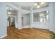 Open living space featuring hardwood floors, white cabinets, and stainless steel appliances at 12698 Whisper Way, Fishers, IN 46037