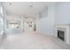 Spacious living room with fireplace, neutral carpet, and an open layout to the kitchen at 12698 Whisper Way, Fishers, IN 46037
