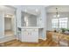 Bright, open-concept room with hardwood floors, and built-in breakfast bar and cabinets at 12698 Whisper Way, Fishers, IN 46037