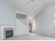 Open-concept living room featuring neutral carpet, fireplace, and staircase to the upper level at 12698 Whisper Way, Fishers, IN 46037