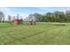 Spacious backyard with outbuildings including a red barn and play equipment for outdoor fun at 1285 S 1100 E, Zionsville, IN 46077