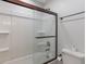 Clean bathroom with a shower and tub combination and a white toilet at 1285 S 1100 E, Zionsville, IN 46077