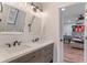 Bathroom boasting a double sink vanity and a peek into an adjacent bedroom at 1285 S 1100 E, Zionsville, IN 46077