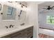 Modern bathroom with double sinks, quartz countertops, and updated fixtures with new tile at 1285 S 1100 E, Zionsville, IN 46077