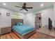 Well-lit bedroom with wood-look floors, a fan, a closet, and a dresser for ample storage space at 1285 S 1100 E, Zionsville, IN 46077