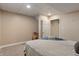 Neutral bedroom showcasing a large bed with modern bedding near the open door at 1285 S 1100 E, Zionsville, IN 46077