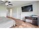 Spacious bedroom featuring wood-look floors and a mounted TV and desk area, great for work and relaxation at 1285 S 1100 E, Zionsville, IN 46077