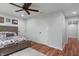 Bedroom with a ceiling fan and wood-look flooring and a rustic bed frame and cabin-themed decor at 1285 S 1100 E, Zionsville, IN 46077