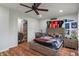 Bedroom with ceiling fan, hardwood floors, and sports-themed decor with a closet at 1285 S 1100 E, Zionsville, IN 46077