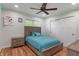 Cozy bedroom with a wood-frame bed, ceiling fan, and natural light at 1285 S 1100 E, Zionsville, IN 46077