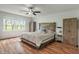 Spacious bedroom featuring a wooden platform bed, a ceiling fan, and a bright window view at 1285 S 1100 E, Zionsville, IN 46077