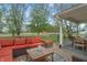 Inviting outdoor deck with an orange outdoor sofa, coffee table, and a dining table at 1285 S 1100 E, Zionsville, IN 46077