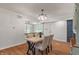 Bright dining room features a modern light fixture and stylish furniture with wood flooring throughout at 1285 S 1100 E, Zionsville, IN 46077