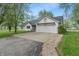 Charming home with a clean white painted brick facade, a well-manicured lawn, and a spacious driveway at 1285 S 1100 E, Zionsville, IN 46077