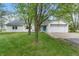Quaint exterior view of the home showcasing its well-kept lawn, inviting entrance, and attached two-car garage at 1285 S 1100 E, Zionsville, IN 46077